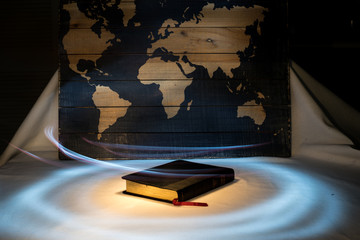 Light of the World Light Painting of Holy Bible with Map
