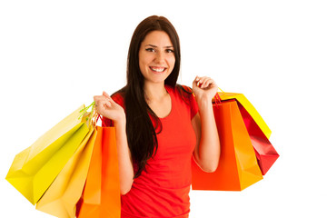 attractive young woman holding shopping bags isolated over white background