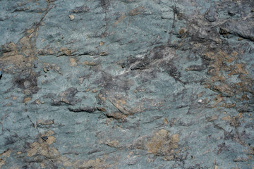 Natural gray stony inhomogeneous uneven grunge background.