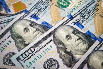 New one hundred dollar bills background with vignette effect