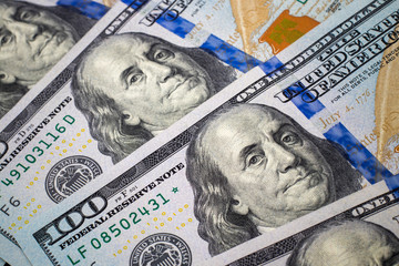 New one hundred dollar bills background with vignette effect