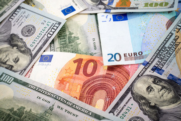 New one hundred dollar and euro bills background with vignette effect