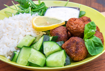 vegan dish with soymeatballs, cucumber,rice and yogurt sauce
