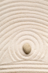 Fototapeta na wymiar Zen sand and stone garden with raked lines, curves and circles. Simplicity, concentration or calmness abstract concept