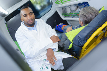 Portrait of paramedic in ambulance with patient