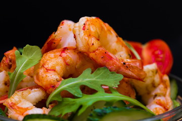 Food. Langoustines salad, black background