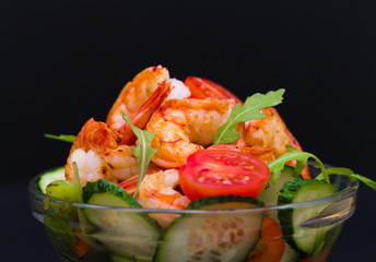 Food. Langoustines salad, black background