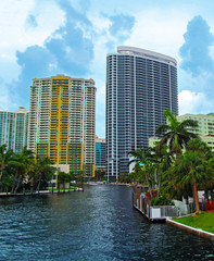 Fort Lauderdale, Florida, USA.
Skyline view of downtown with canal, buildings, palm trees and boats on cloudy day. 