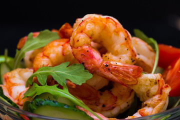 Food. Langoustines salad, black background