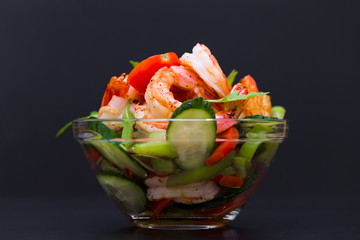Food. Langoustines salad, black background