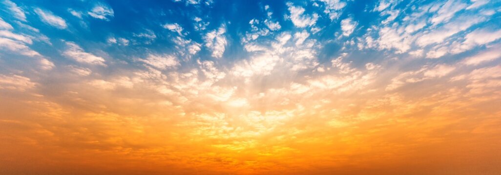 Panorama background of cloudy blue and orange sky