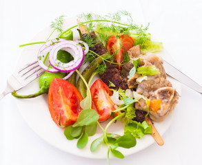 Food. Plate:  tomato, pepper, meat, leaves greenery, lamb