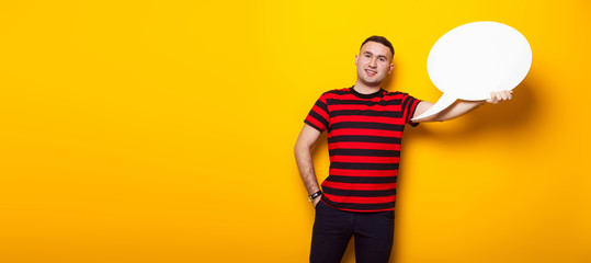Handsome man in bright T-shirt with speech bubble