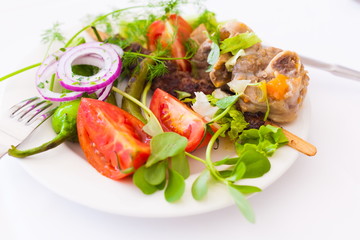 Food. Plate:  tomato, pepper, meat, leaves greenery, lamb