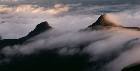 Fototapeta na wymiar Mountain peaks in the clouds. Sunrise on Adam's Peak