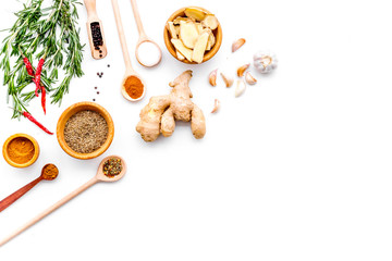 Seasoning background. Dry spices near ginger, garlic, rosemary, chili on white background top view copy space