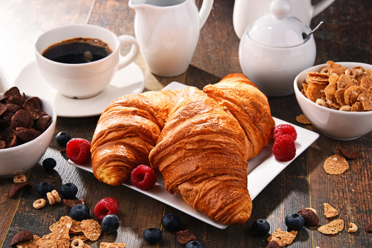 Breakfast served with coffee, croissants, cereals and fruits