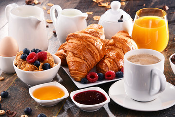 Breakfast served with coffee, juice, croissants and fruits - obrazy, fototapety, plakaty