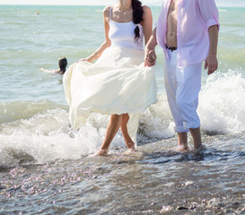 Young happy couple on the beach