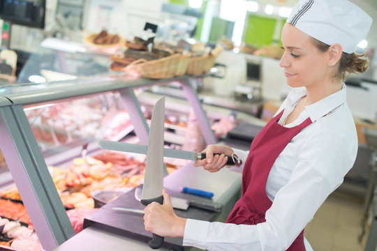 female butcher works at a supermarket