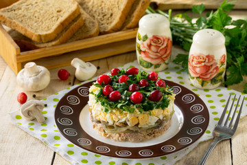 Easter recipe, festive appetizer. Salad with red fish, mushrooms, cheese and cranberries - on the festive table.