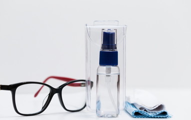 Glasses, napkins, liquid in a bottle, white background