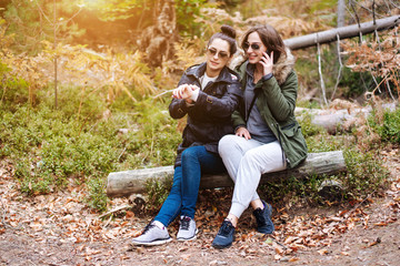 two beautiful girls sat down in the forest