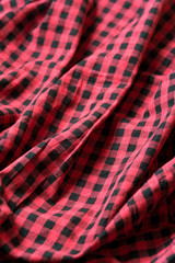 Red and black classic checkered cotton fabric. Plaid texture, male cloth design