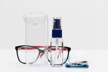 Glasses, napkins, liquid in a bottle, white background