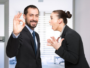 Man happy while a woman is shouting at him