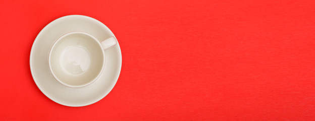 Empty cup of coffee on red background banner template with copyspace