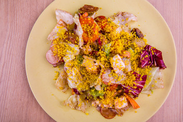 Chicken fillet, red cabbage, garden radish and vegetables salad