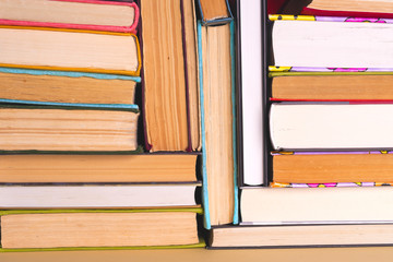 Fototapeta premium Open book, hardback books on bright colorful background.