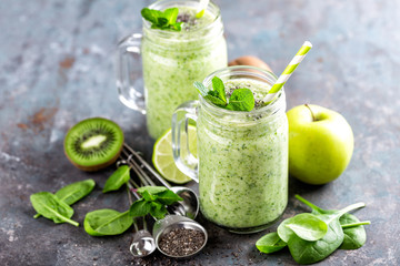 green smoothie with spinach, apple, kiwi, lime and chia seeds. healthy diet eating, superfood