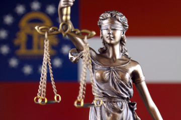 Symbol of law and justice with Georgia State Flag. Close up.