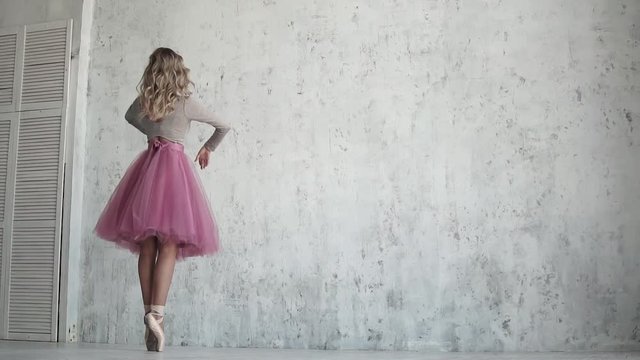 dancer ballet pirouette on toes in pointe shoes. ballet dancer in a pink tutu. slow motion