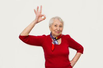 Smiling senior lady gesturing perfect sign