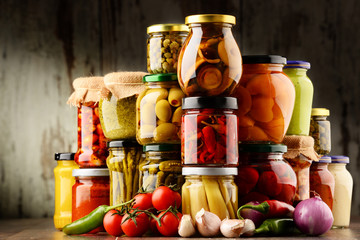 Jars with variety of pickled vegetables.