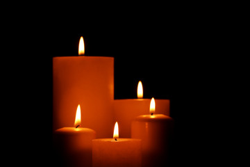 Burning candles on black background