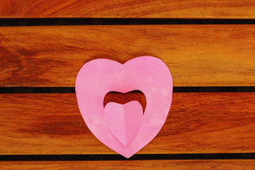 Valentine card with pink heart  on floor wood, concept love with copy space