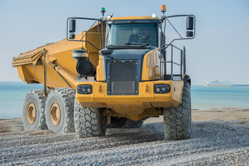 Construction Site - Engineering - Sea Defence. Large plant machinery being use to build the beach sea defence at Seaford, East Sussex, UK