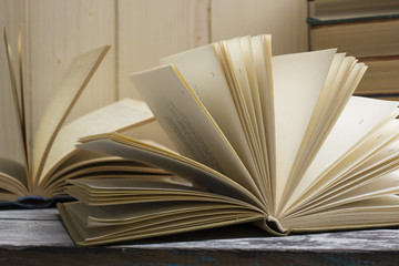 Open book, hardback books on wooden table. Back to school. Copy space
