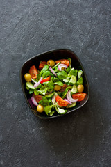 Mediterranean-style salad with lettuce corn, olives, tomatoes and onions
