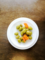 green olives in white bowl on table