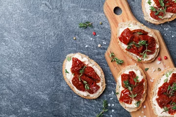 Tischdecke Bread slices with cream cheese and sun dried tomatoes on wooden table top view. Delicious snack and appetizer. © juliasudnitskaya