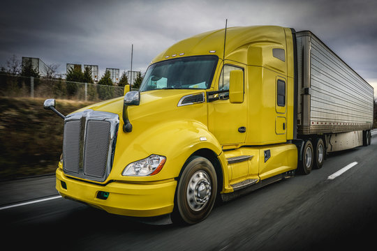 Big yellow 18 wheeler truck on highway