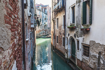 VENICE, ITALY - FEBRUARY 10 2018: Gondolas sailing in small canals of Venice near San Marco