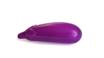 .purple plastic eggplant on white background