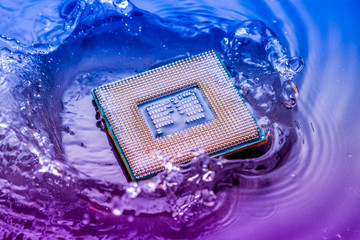 technology cyber electronic concept. cpu ram computer Fall into the water on blue light background. CPU cooling with water