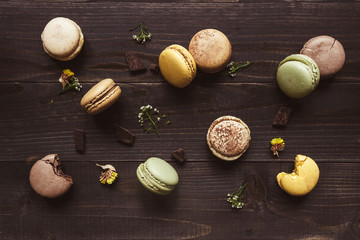 Sweet background. Delicious macaroons on the wooden table, top view